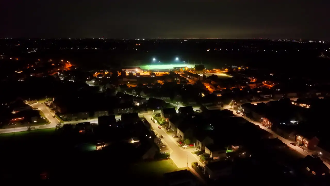 Een verlicht sportveld in Eppegem bij nacht